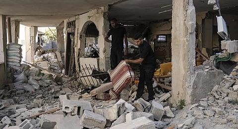 Palestinians inspect a damaged house in the Jenin refugee camp in the West Bank. (Photo | AP)