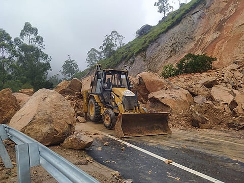 Authorities trying to remove the boulders and the heaps of mud on the Munnar-Theni interstate highway. (Express)