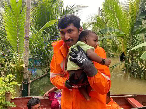 Fire and Rescue Services personnel shifting a toddler to a safer place after flood water gushed into the house at Thalavady in Kuttanad on Thursday.