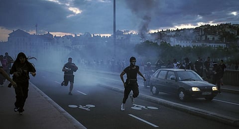 People run away during clashes with police in the center of Lyon, central France. (Photo | AP)