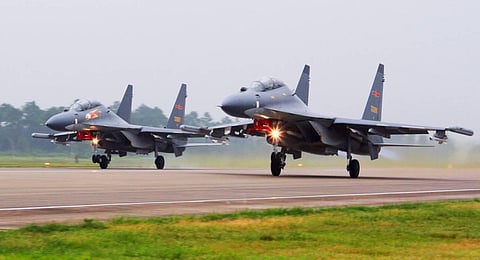 Two Chinese SU-30 fighter jets take off from an unspecified location to fly a patrol over the South China Sea. (Photo | AP)