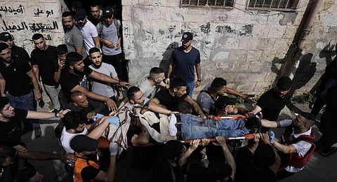 Palestinians carry the body of a man killed during an Israeli military raid in the West Bank city of Nablus. (Photo | AP)