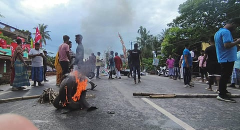 Supporters block a road in protest against the killing of an independent candidate during panchayat polls, at Barasat. (Photo | PTI)