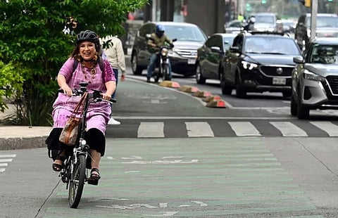 Former Mexican Senator Xochitl Galvez arrives by bicycle before registering as a presidential pre-candidate for the Frente Amplio por Mexico coalition in Mexico City on July 4, 2023. (AFP)