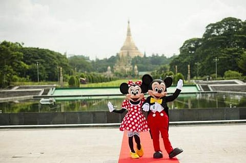 A file photo of Walt Disney characters Mickey Mouse (R) and Minnie Mouse pose for photographs | AFP