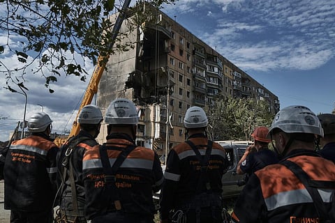 Emergency services work at a scene after a missile hit an apartment building in Kryvyi Rih, Ukraine on July 31, 2023.(Photo | AP)