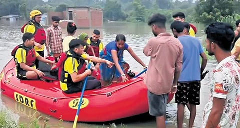 SDRF teams rescue residents of Sitarganj due to flooding in the area. (Photo | Express)