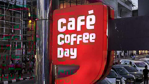 The Cafe Coffee Day logo board is seen outside one of its outlet. (File | AFP)