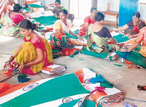 Women workers pack national flags at a textile manufacturing unit in Sircilla on Thursday. The government is paying these women Rs 12 per flag