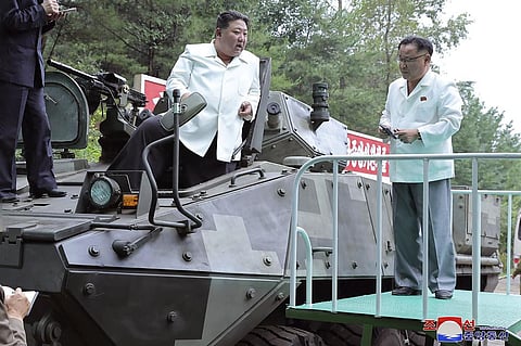 North Korean leader Kim Jong Un (C) rides on an armored vehicle during his Aug. 11-12 visit to a military factory in Pyongyang. (Photo | AP)