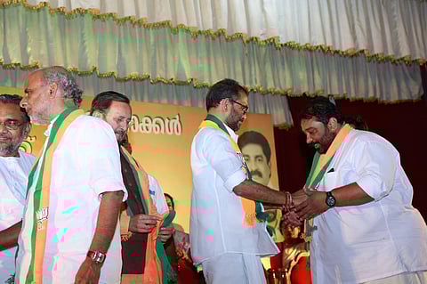 BJP Kerala president K Surendran welcomes new members to the party on Sunday. BJP's Kerala in-charge Prakash Javadekar looks on. (Photo | Special Arrangement)