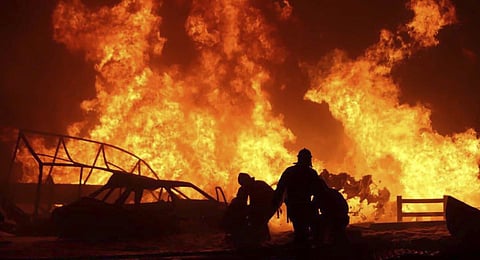 Rscuers pushing out a fire at a gas station in the city of Makhachkala. (Photo | AFP)
