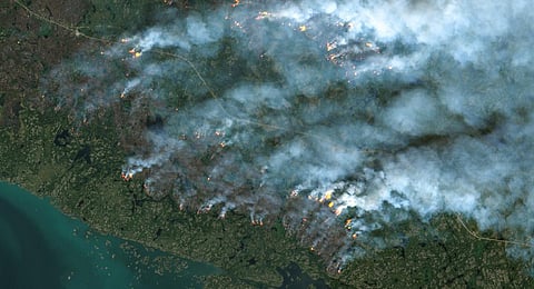 This handout satellite image courtesy of the European Space Agency's Copernicus Sentinel-2 sattelite shows fires burning in Yellowknife, Northwest Territories, Canada. (Photo | AFP)