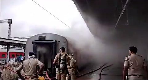 Fire department officials attempt to douse the fire which broke out in Udyan Express at the KSR Bengaluru City railway station on Saturday, Aug 19, 2023. (Photo | Special Arrangement)