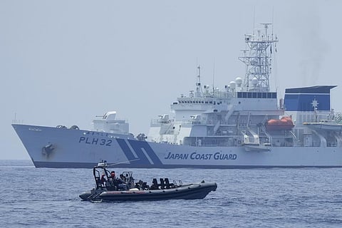 FILE - A Philippine Coast Guard boat passes by the Japanese Coast Guard during a trilateral Coast Guard drill of US, Japan and Philippines in Bataan province, Philippines, June 6, 2023.(Photo | AP)