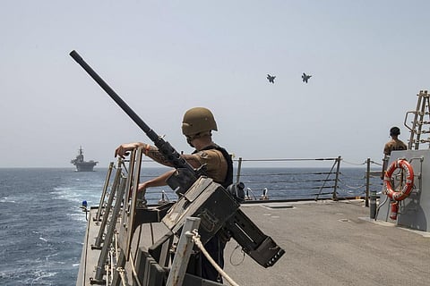 Two U.S. Air Force F-35A Lightning II fighter jets fly alongside amphibious assault ship USS Bataan and guided-missile destroyer USS Thomas Hudner in the Gulf of Oman, Aug. 17, 2023. (Photo |AP)