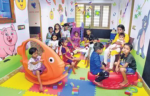 Children of migrant workers at the mobile creche at Vengola in Perumbavoor spending their time with teachers | A Sanes h