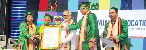 Secretary of department of Atomic Energy Ajit Kumar Mohanty being conferred the Honoris Causa by Governor Prof Ganeshi Lal on Saturday