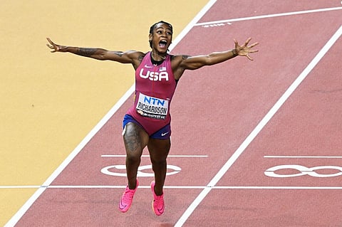 USA's Sha'Carri Richardson reacts after crossing the finish line to win the women's 100m final during the World Athletics Championships at the National Athletics Centre in Budapest . (Photo | AFP)