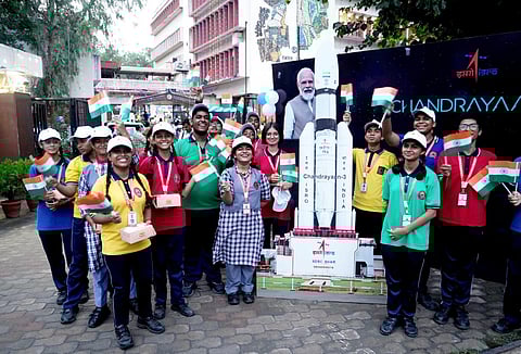 Students celebrate after the successful landing of 'Chandrayaan-3' on the Moon's surface, at CSIR headquarters, in New Delhi. (PTI)