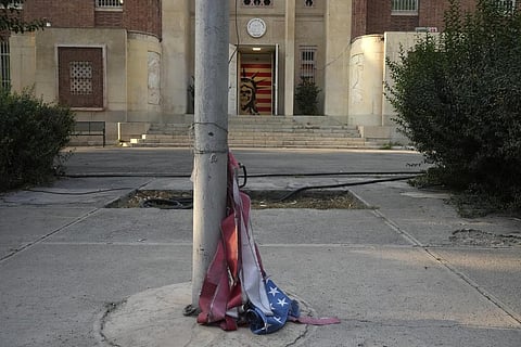 A torn U.S flag is placed under a flagpole at the former U.S. Embassy, which has been turned into an anti-American museum, in Tehran, Iran (AP)