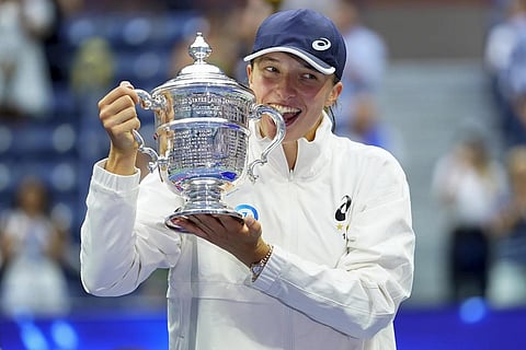 Iga Swiatek poses with the championship trophy after defeating Ons Jabeur in the women's singles finals of the US Open tennis championship, Sept 10, 2022. (File Photo | AP)