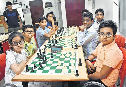 Young students from Coach RB Ramesh’s academy, Chess Gurukul, watch the screening of the summit clash