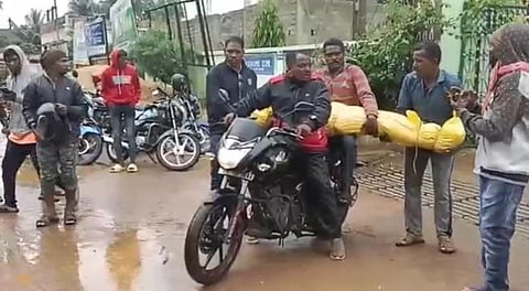 Biswanath Gemel’s body being carried on a motorcycle. (Photo | Express)