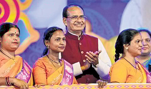Shivraj Singh Chauhan celebrates Raksha Bandhan during a ‘Ladli Behna’ scheme programme, at Jamburi Maidan in Bhopal on Sunday. (Photo | PTI)