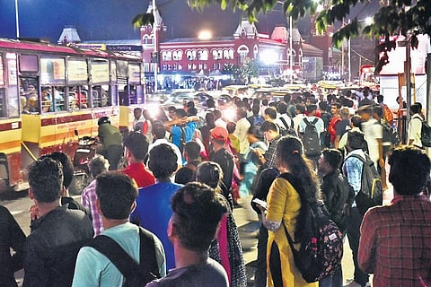 Commuters wait for bus service at Central station in Chennai on Monday | P Jawahar