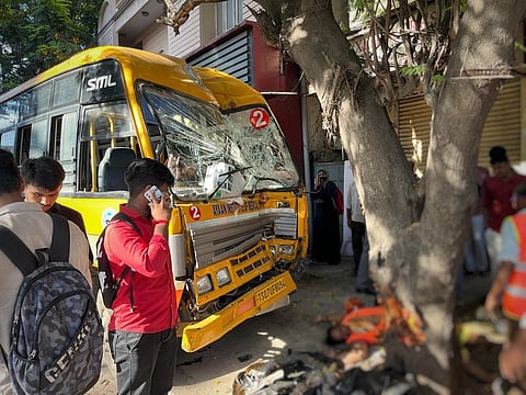 Onlookers gather around the damaged bus in Ramkote, Hyderabad, on Monday. (Photo | Express)