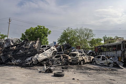 Burnt vehicles are piled up in a transport yard in Nuh in Haryana state, India on Tuesday, Aug., 1, 2023.