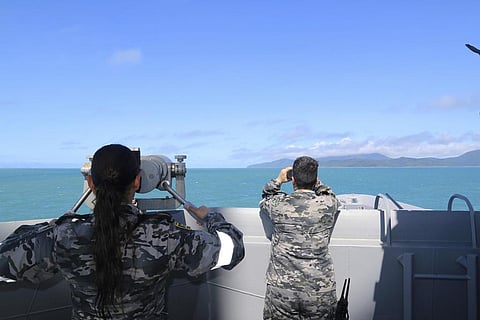 In this photo, Royal Australian Navy sailors from HMAS Brisbane scan the horizon during search and rescue operations in the vicinity of Lindeman Island, Australia. (Photo | AP)