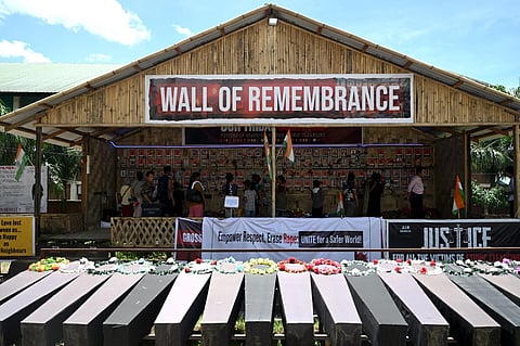 People look at portraits of victims who lost their lives during ethnic clashes, as empty coffins are kept at a memorial in Maipur's Churachandpur district, July 24, 2023. (Photo | AFP)