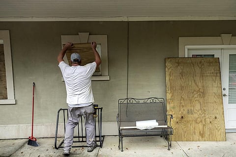Tybee Island, Ga., resident Bryan Moore helps his friend board up his house on the island, Tuesday, Aug. 29, 2023, ahead of Hurricane Idalia. (Photo | AP)