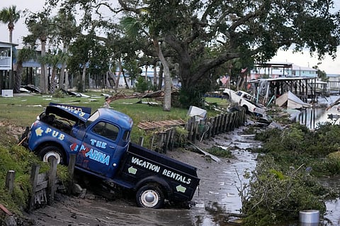 Pick-up trucks and debris lie strewn in a canal in Horseshoe Beach, Florida, after the passage of Hurricane Idalia. (Photo | AP)