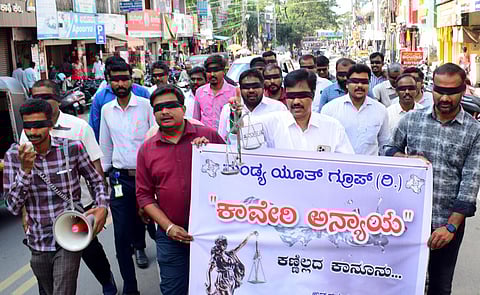 Activists blindfolded with black ribbons held a protest against the release of Cauvery water from the KRS dam to Tamil Nadu in Mandya. (Photo | Express)