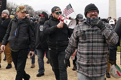 Proud Boys members including Zachary Rehl, left, Ethan Nordean, center, and Joseph Biggs, walk toward the US Capitol in Washington, Jan 6, 2021. (File Photo | AP)