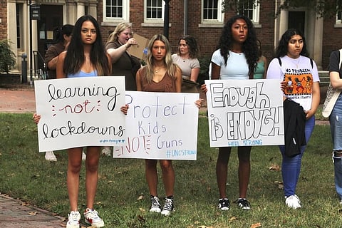 Students hold protest signs during a gun safety rally following a fatal shooting earlier in the week on the University of North Carolina at Chapel Hill campus. (Photo | AP)
