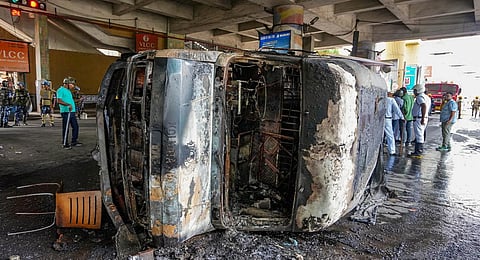 Remains of a burnt vehicle after a clash between police personnel and locals following a road accident in which a student of Barisha High School was killed by a speeding truck.(PTI Photo)