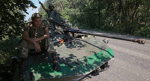 Ukrainian servicemen rest on their airborne infantry fighting vehicle (BMD-1) on the road in Donetsk region. (Photo | AP)