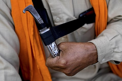 FILE - A man holds his ‘Kirpan’- a sword or a dagger carried by Sikhs as a part of their religious commandment. (Photo | AFP)