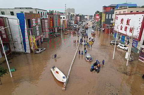 This aerial view shows rescue teams working in a flooded village after heavy rains in Zhuozhou, Baoding city, in northern China’s Hebei province on August 2, 2023. (Photo | AFP)