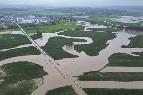In this aerial photo released by Xinhua News Agency, flood waters course through fields and roads in Kaiyuan Town of Shulan in northeastern China's Jilin Province on Friday, Aug. 4, 2023. (Photo | AP)