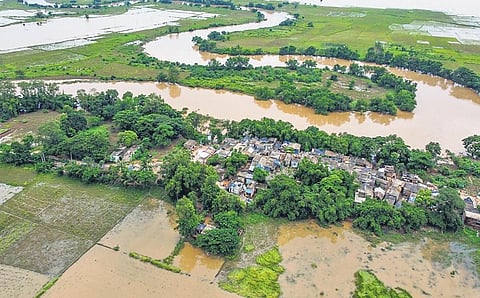 A village surrounded by flood water of Mahandi river at Banki in Cuttack, on Friday | DEBADATTA MALLICK