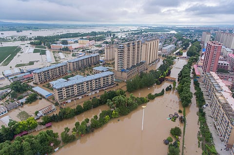 Flood waters cover Yanshou County of Harbin in northeastern China's Heilongjiang Province on Saturday. (Photo | AP)
