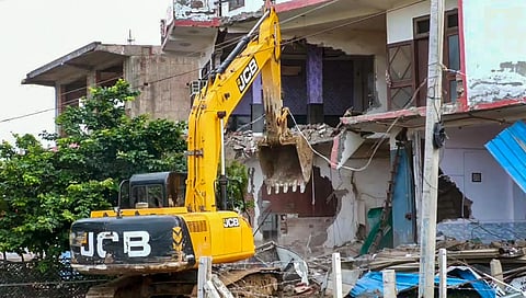 Bulldozer being used to demolish the 'illegally constructed' Sahara hotel in violence-hit Nuh district, Sunday, Aug. 6, 2023. (Photo | PTI)