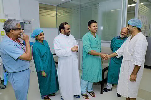 Fr. George meets Jojomon before being discharged. Also seen are Rajagiri Hospital Administration Director Fr.Joy Kilikunnel, Dr Jose Thomas and Dr Balagopal Nair. (Photo | Special arrangement)