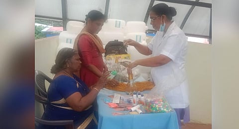 Bystanders learning to make glass bottle LED lights at the dialysis unit