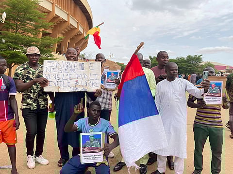 Supporters of Niger's ruling junta hold a Russian flag in Niamey, Niger. (Photo | AP)